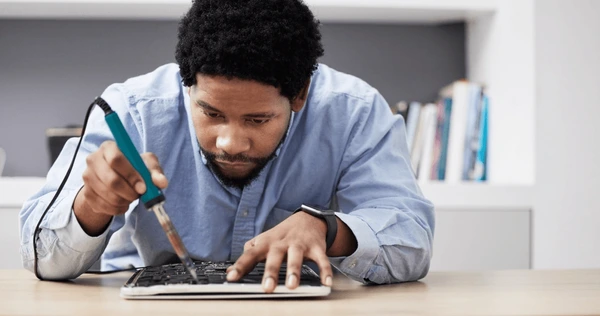 black man soldering iron fixing 600nw 2353168805